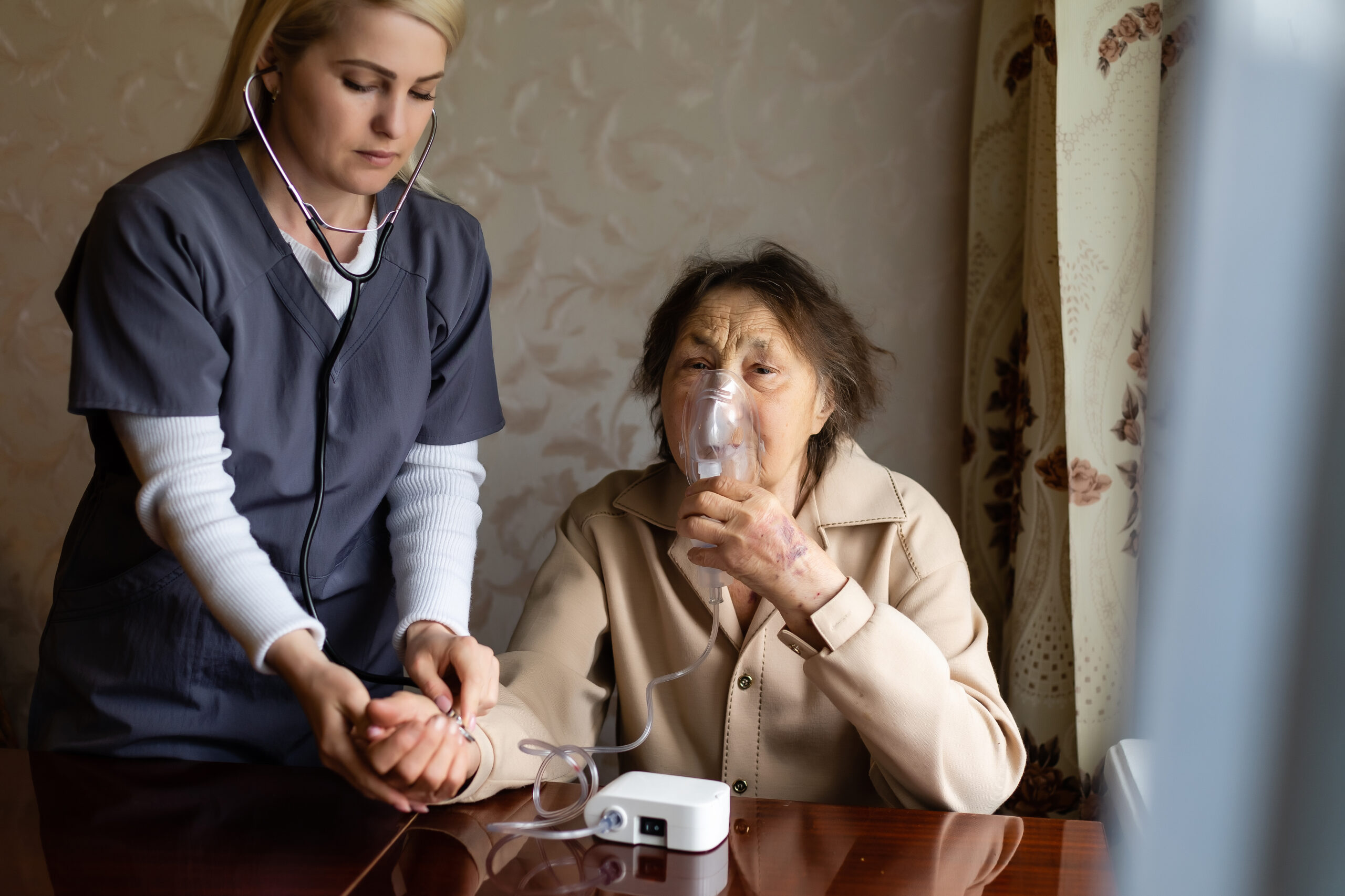 kind young female nurse caring for a very old female patient, hospital freepic